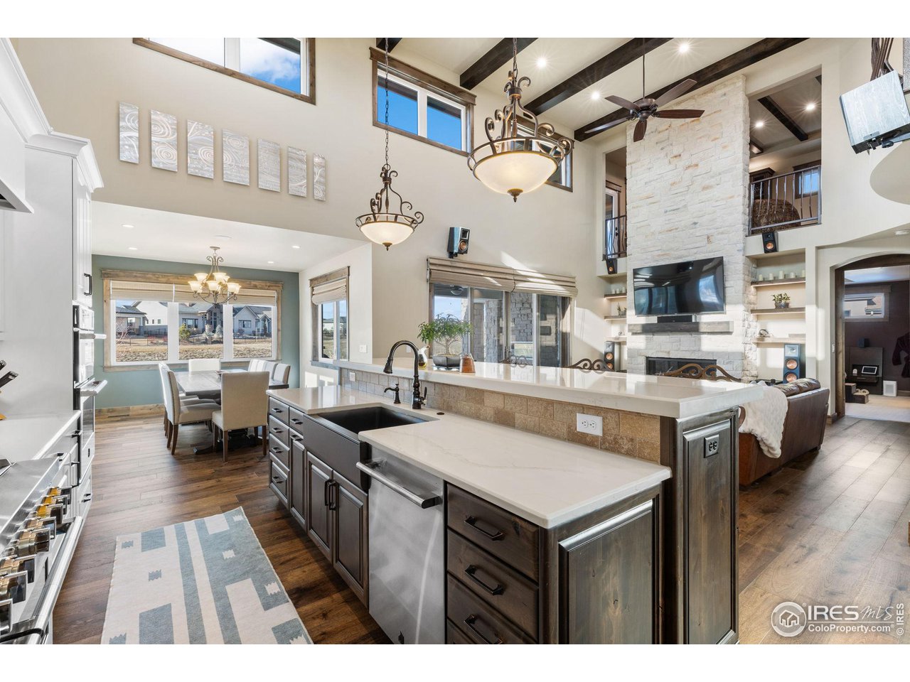 2770 Heron Lakes Parkway Berthoud, CO 80513 - Photo 12 of 40 a kitchen with stainless steel appliances granite countertop a stove and a view of living room