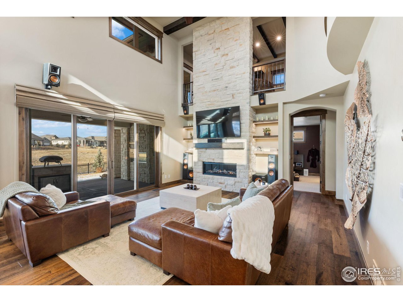 2770 Heron Lakes Parkway Berthoud, CO 80513 - Photo 14 of 40 a living room with fireplace furniture and a wooden floor