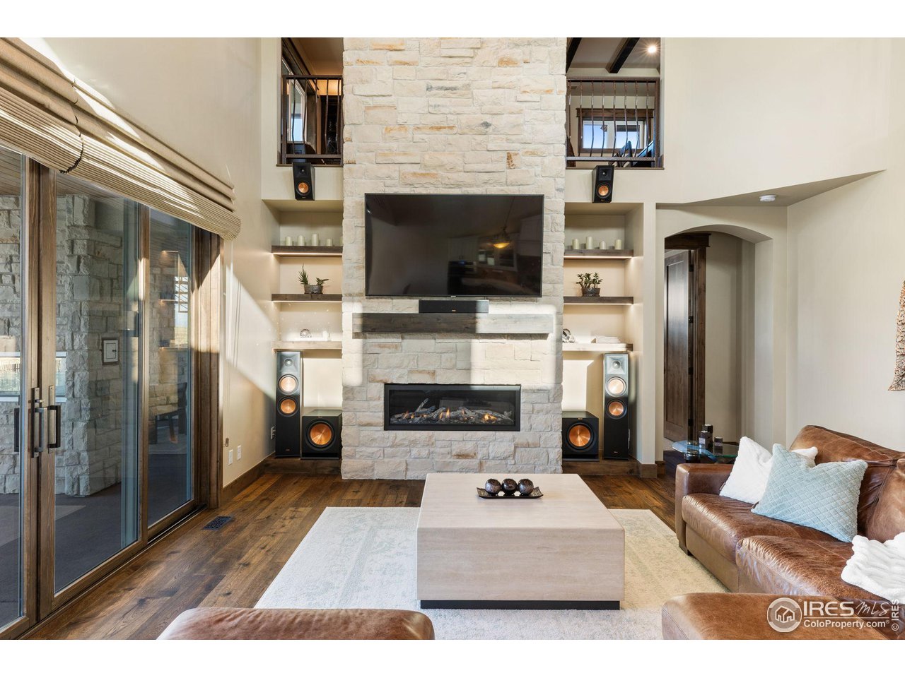 2770 Heron Lakes Parkway Berthoud, CO 80513 - Photo 15 of 40 a living room with furniture a fireplace and a flat screen tv