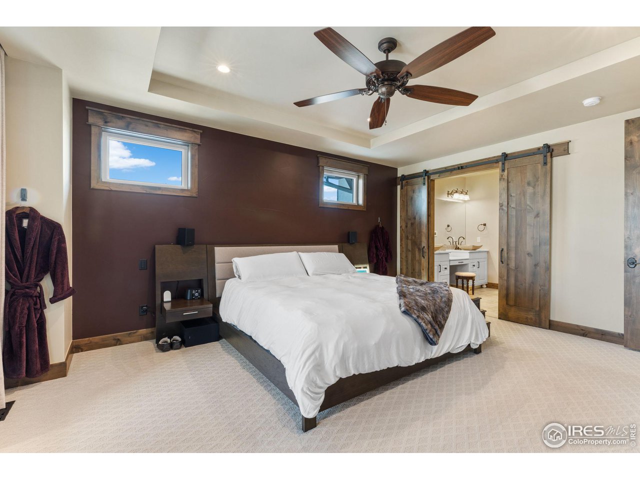2770 Heron Lakes Parkway Berthoud, CO 80513 - Photo 21 of 40 a bedroom with a bed gym equipment and a ceiling fan