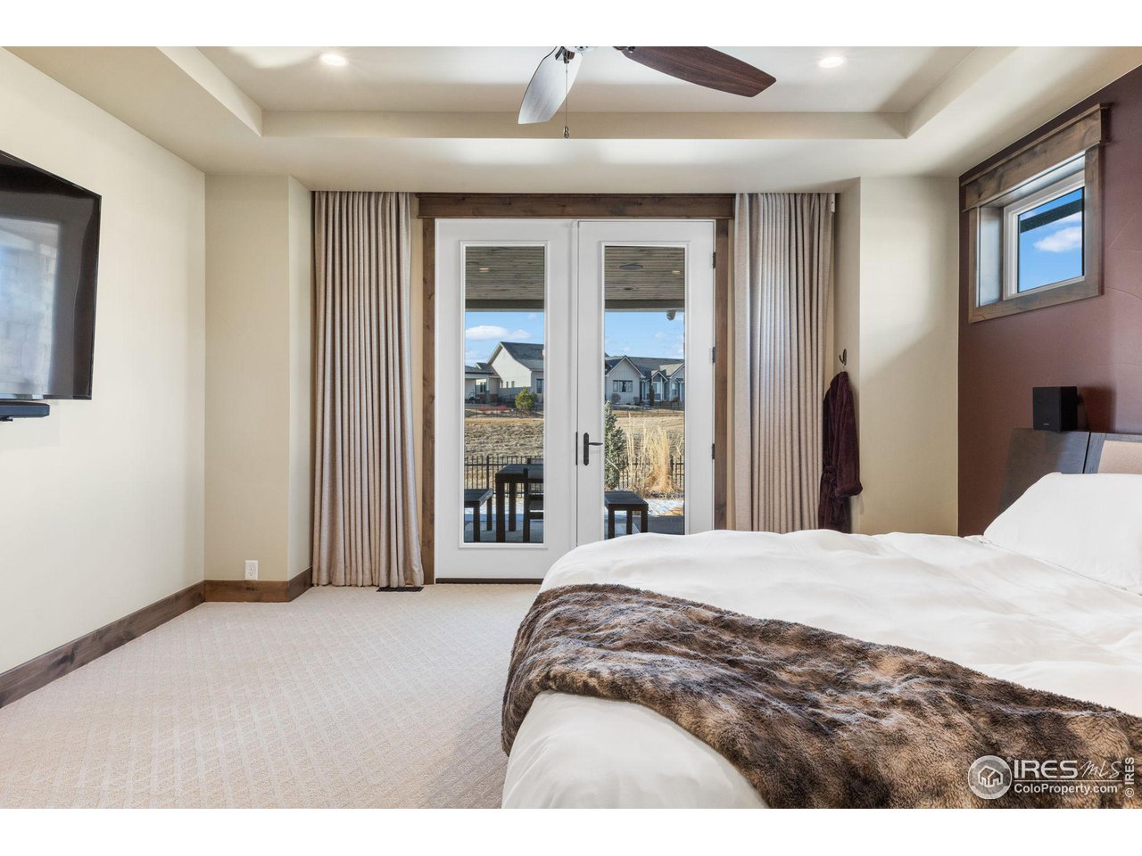 2770 Heron Lakes Parkway Berthoud, CO 80513 - Photo 22 of 40 a bedroom with a bed and a large mirror