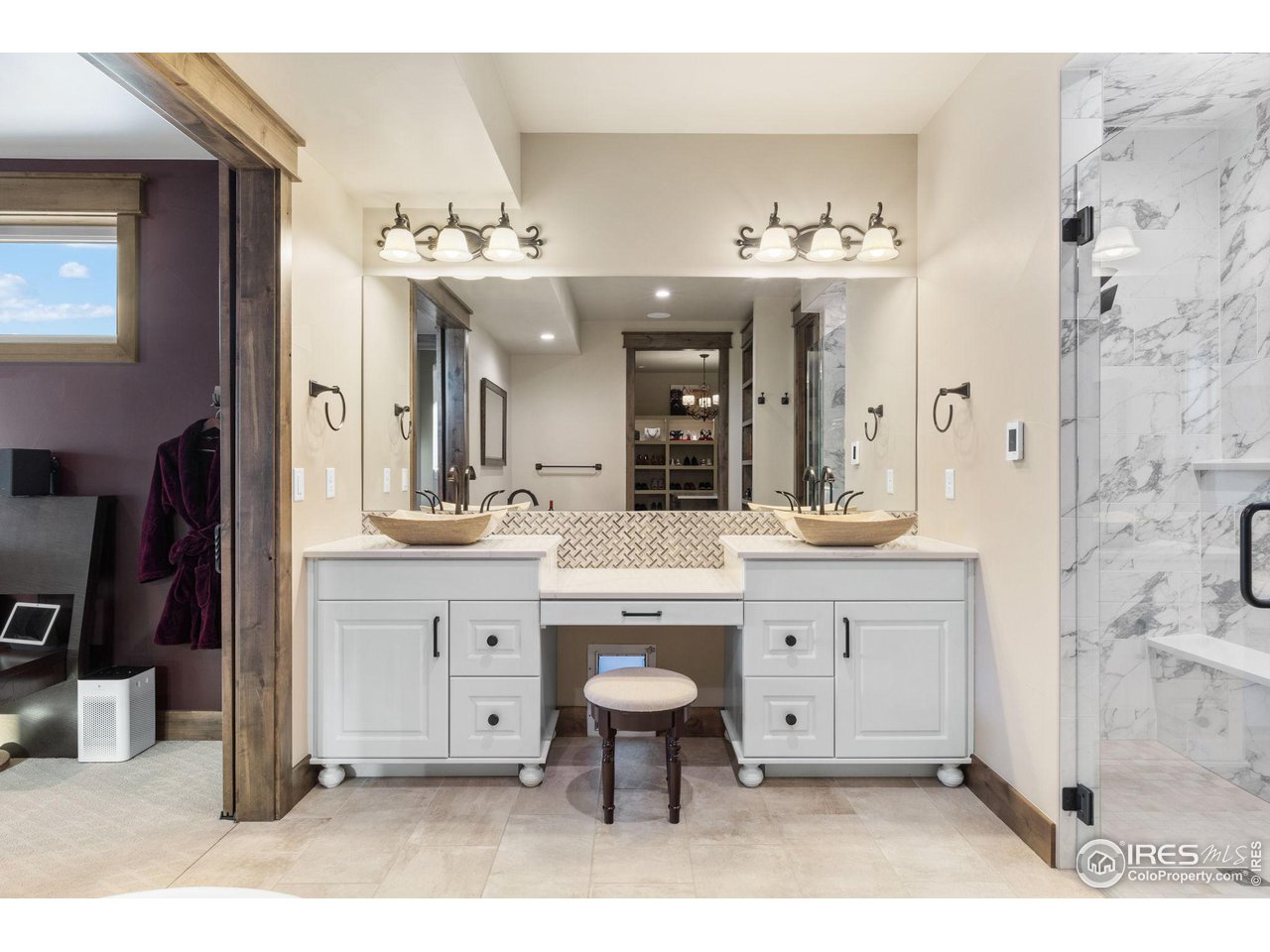 2770 Heron Lakes Parkway Berthoud, CO 80513 - Photo 24 of 40 a spacious bathroom with a double vanity sink a mirror a bathtub and a shower