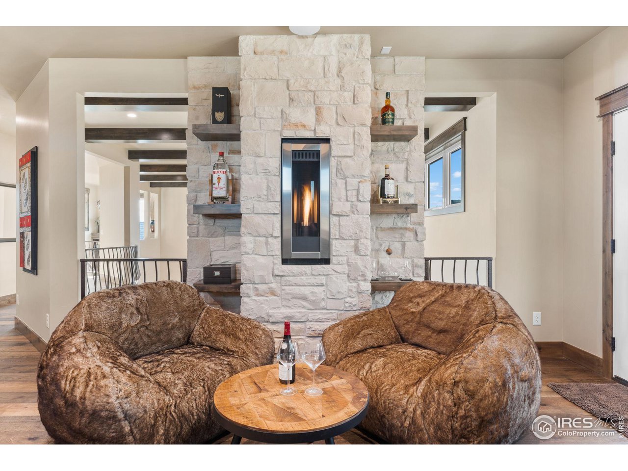 2770 Heron Lakes Parkway Berthoud, CO 80513 - Photo 28 of 40 a living room with furniture and a fireplace