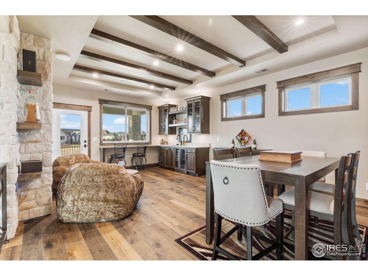 2770 Heron Lakes Parkway Berthoud, CO 80513 - Photo 30 of 40 a living room with furniture a dining table and wooden floor