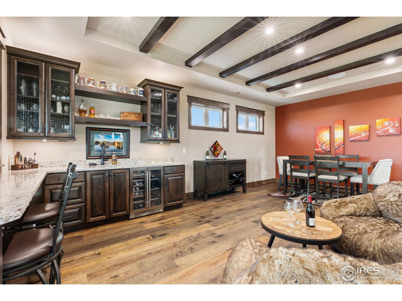 2770 Heron Lakes Parkway Berthoud, CO 80513 - Photo 31 of 40 a room with stainless steel appliances kitchen island granite countertop a table chairs and a refrigerator
