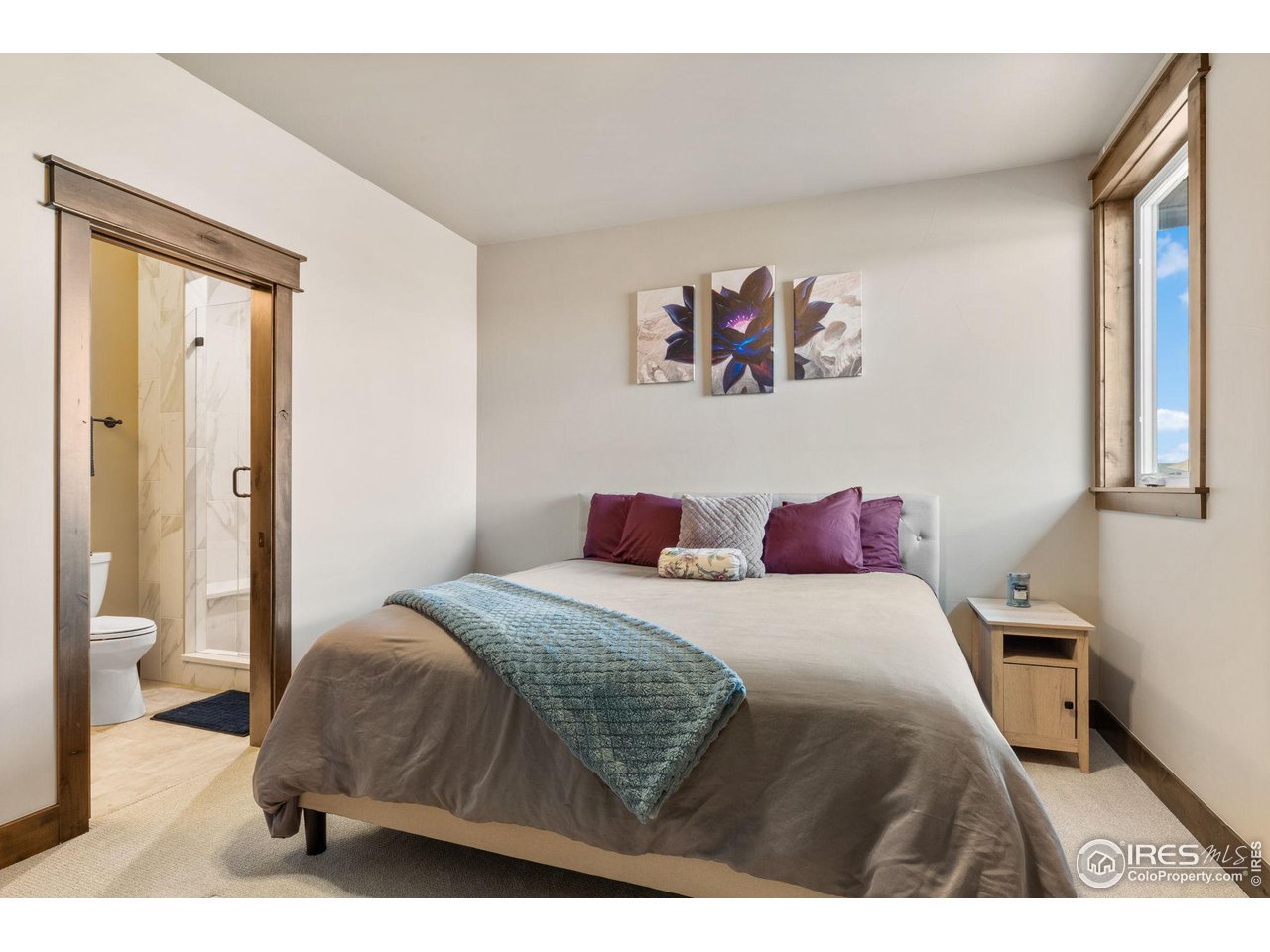 2770 Heron Lakes Parkway Berthoud, CO 80513 - Photo 34 of 40 a bedroom with a bed and a painting on the wall