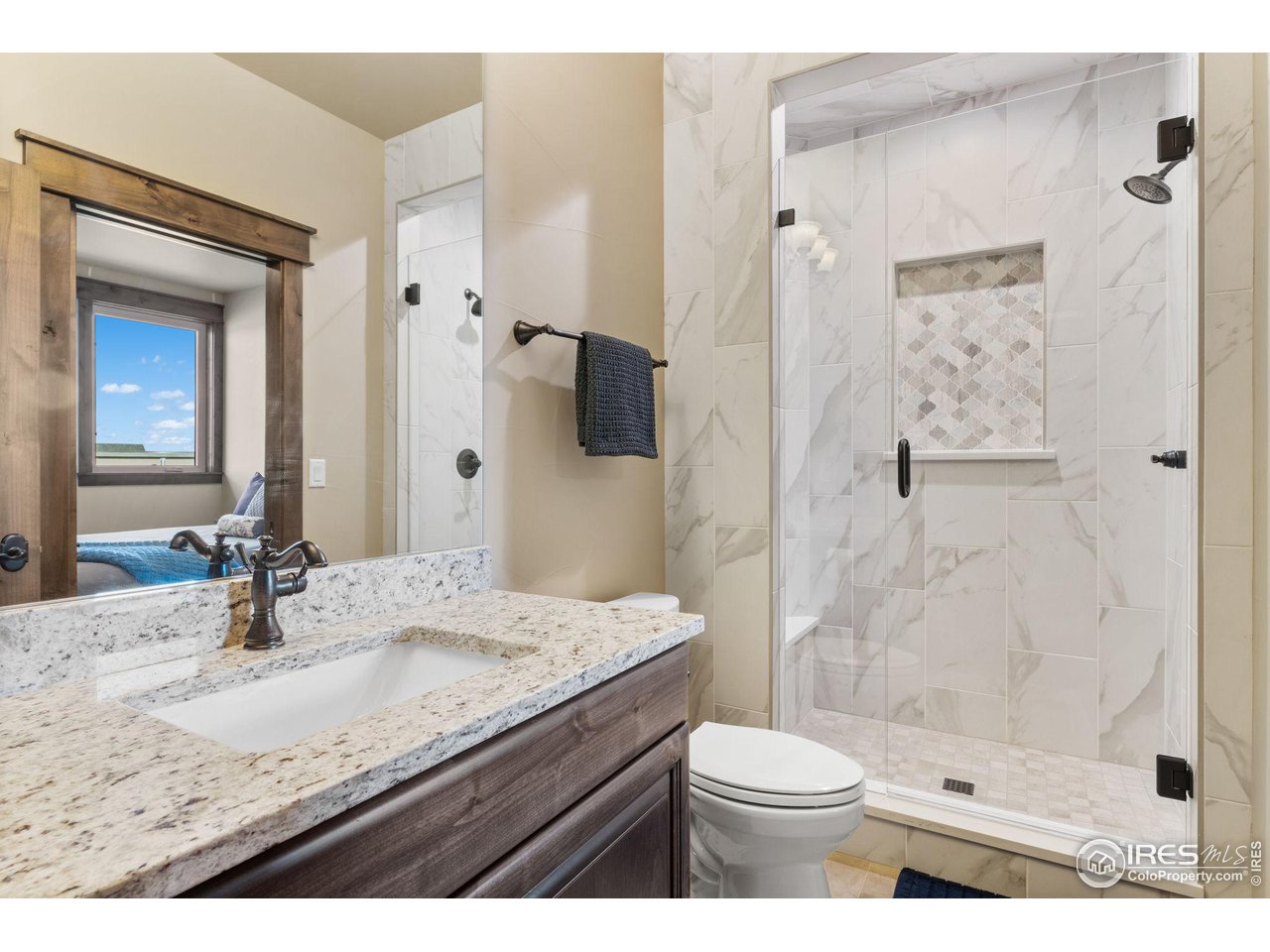 2770 Heron Lakes Parkway Berthoud, CO 80513 - Photo 35 of 40 a bathroom with a granite countertop sink toilet and shower