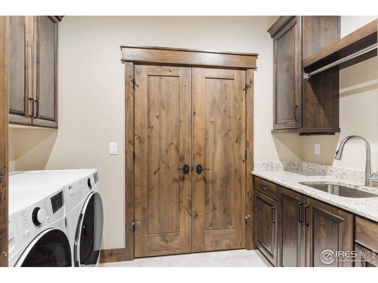 2770 Heron Lakes Parkway Berthoud, CO 80513 - Photo 37 of 40 a bathroom with a granite countertop sink a mirror and shower