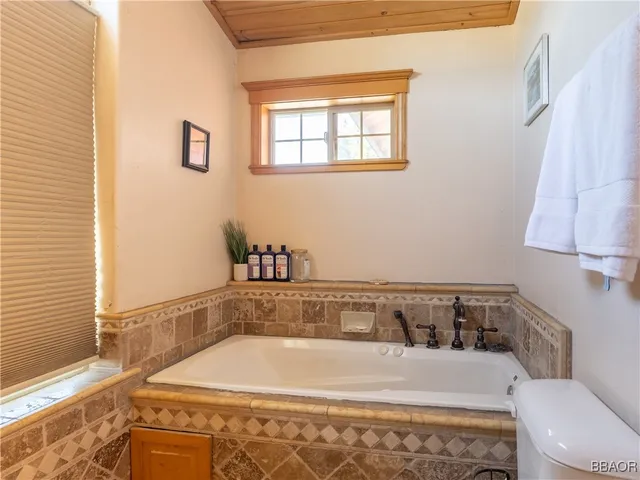 a bathroom with a bathtub and a window