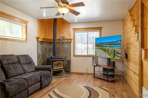a living room with furniture a window and a chandelier