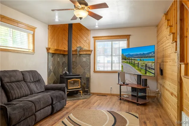 a living room with furniture a window and a chandelier