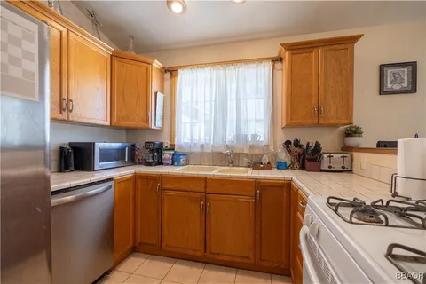 a kitchen with a sink stove top oven and cabinets