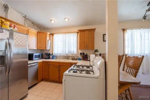 a kitchen with stainless steel appliances granite countertop a refrigerator a stove and a refrigerator