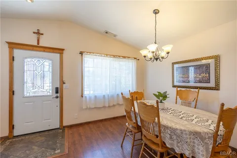 a view of a dining room with furniture and chandelier