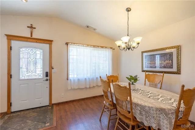 a view of a dining room with furniture and chandelier