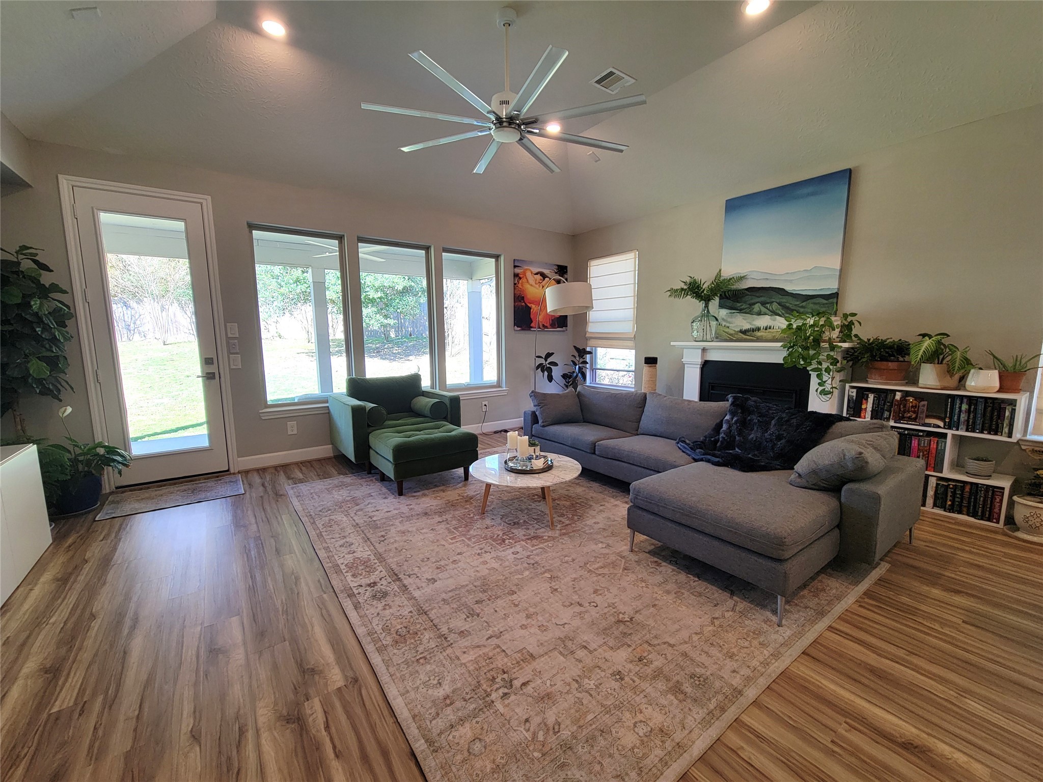 2095 Parnevik Place Conroe, TX 77304 - Photo 6 of 23 The living room features coved, high ceilings and a wall of windows looking out to the backyard.