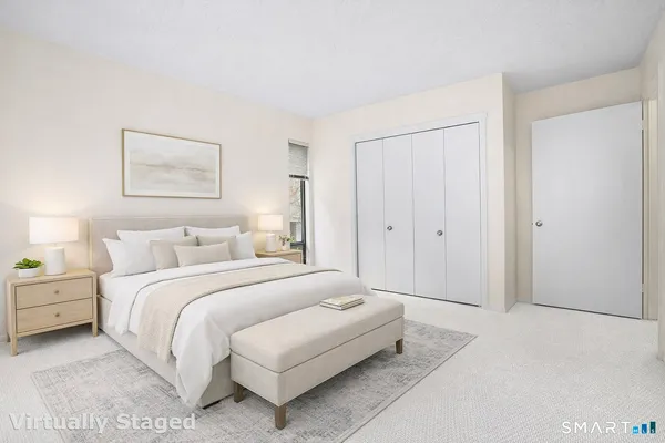 a bedroom with a bed and a painting on the wall
