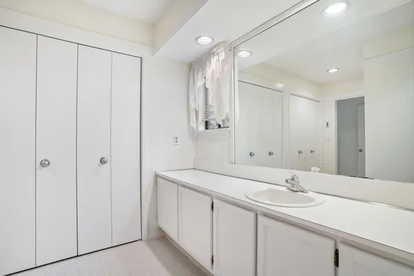 a bathroom with a double vanity sink and a mirror