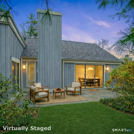 a view of a house with a backyard porch and sitting area