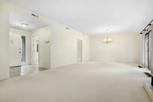 an empty room with a ceiling fan and bathroom