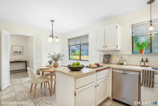 a kitchen with a sink cabinets and window