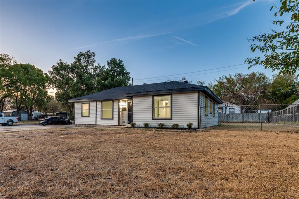 514 Chickapoo Trace Grand Prairie, TX 75051 - Photo 2 of 25 Single-story residence featuring light-colored siding, a dark-shingle roof, and dark-framed windows