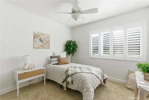 a bedroom with a bed and a potted plant