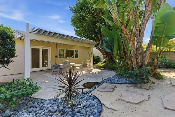 a view of a backyard with plants and a garden