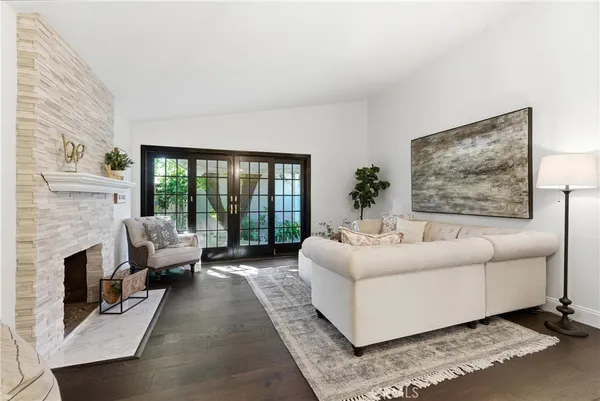 a living room with furniture large window and a fireplace