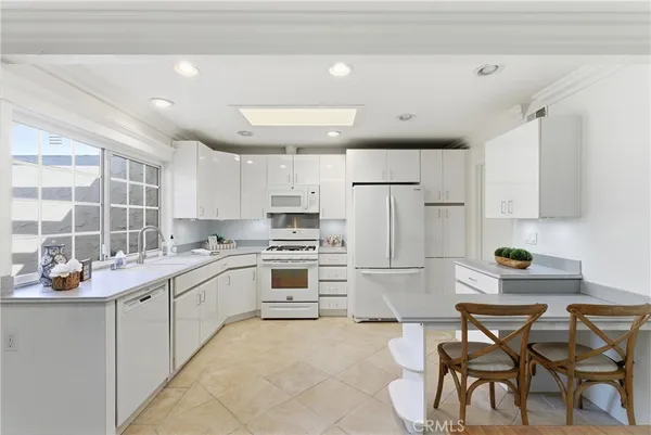 a kitchen with a sink appliances and cabinets