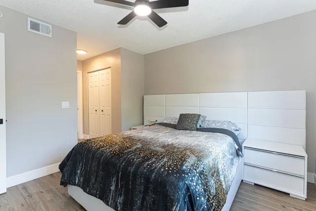 a bedroom with a bed and a chandelier