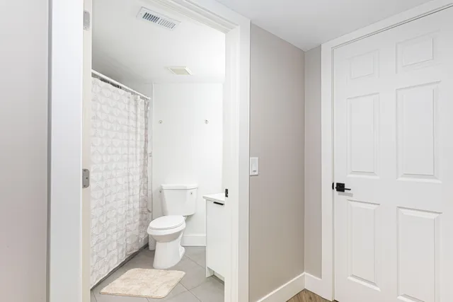 a bathroom with a toilet and a shower