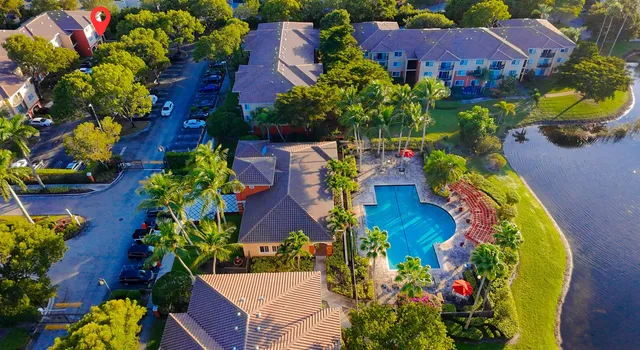 a view of a house with a lot of flower plants