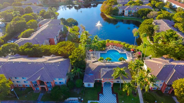 an aerial view of a house with a yard and outdoor seating