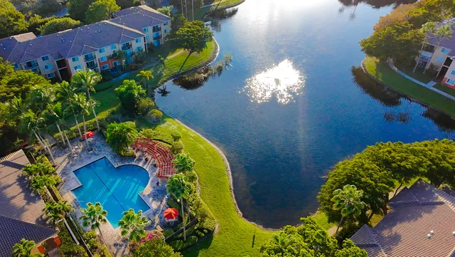 an aerial view of a house with a yard and swimming pool