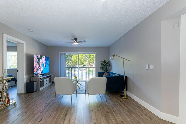 a view of a livingroom with furniture window and wooden floor