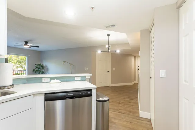 a kitchen with a sink a counter space and stainless steel appliances