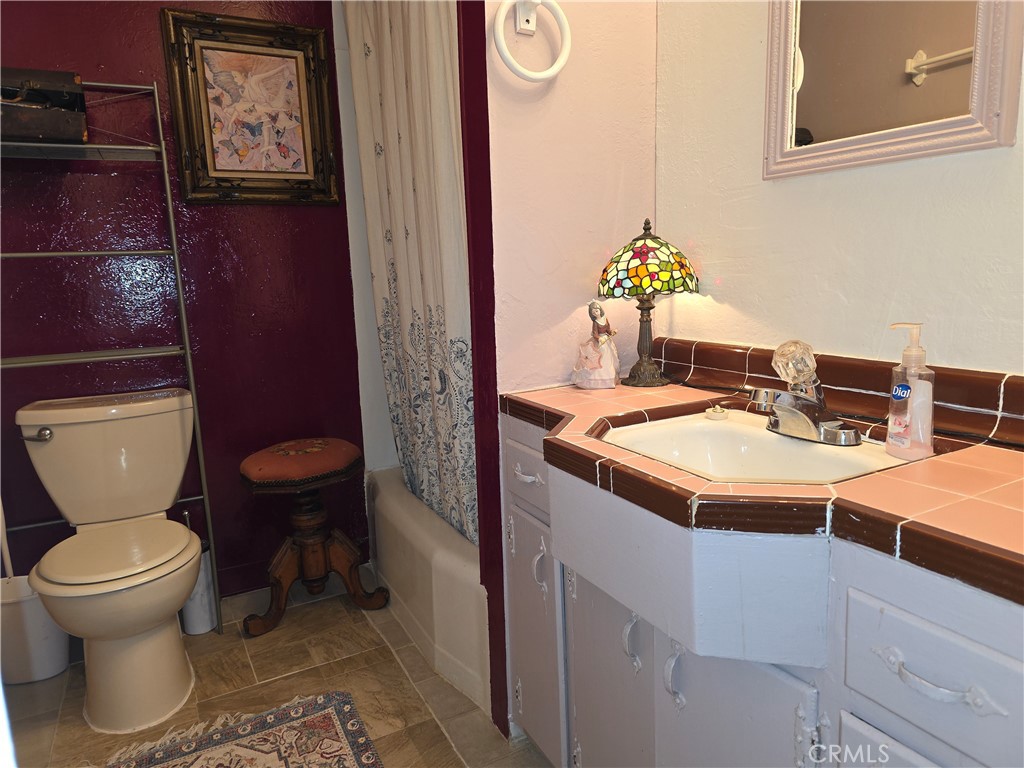 16061 Dam Road Clearlake, CA 95422 - Photo 19 of 37 a bathroom with a toilet sink and mirror