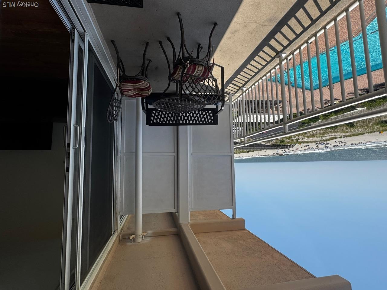 830 Shore Road, Unit 4M Long Beach, NY 11561 - Photo 14 of 20 Balcony featuring view of pool and view of water and beach