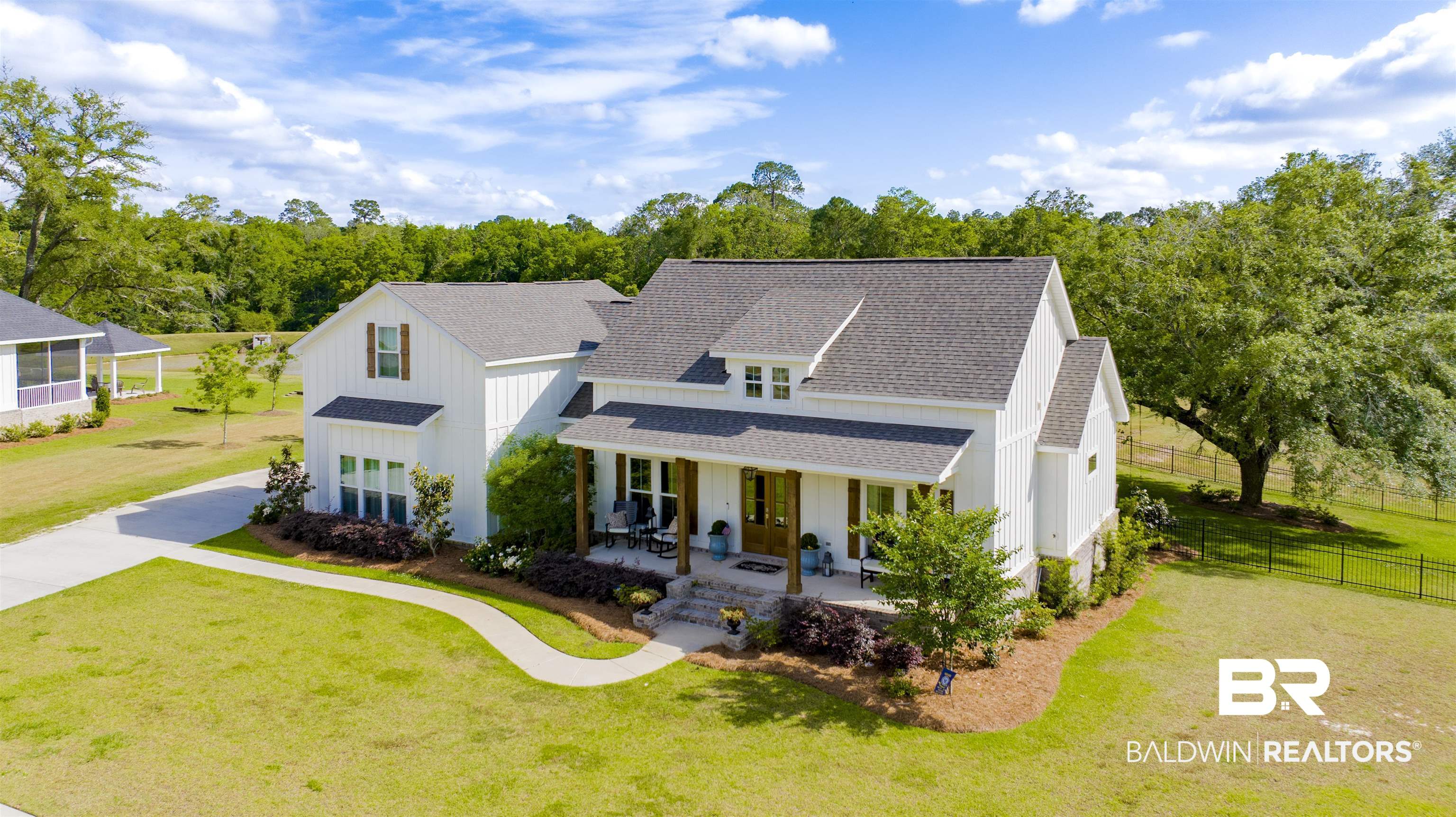 21621 Veranda Boulevard Fairhope, AL 36532 - Photo 43 of 51 Modern farmhouse style home featuring board and batten siding, fence, a shingled roof, and a front yard