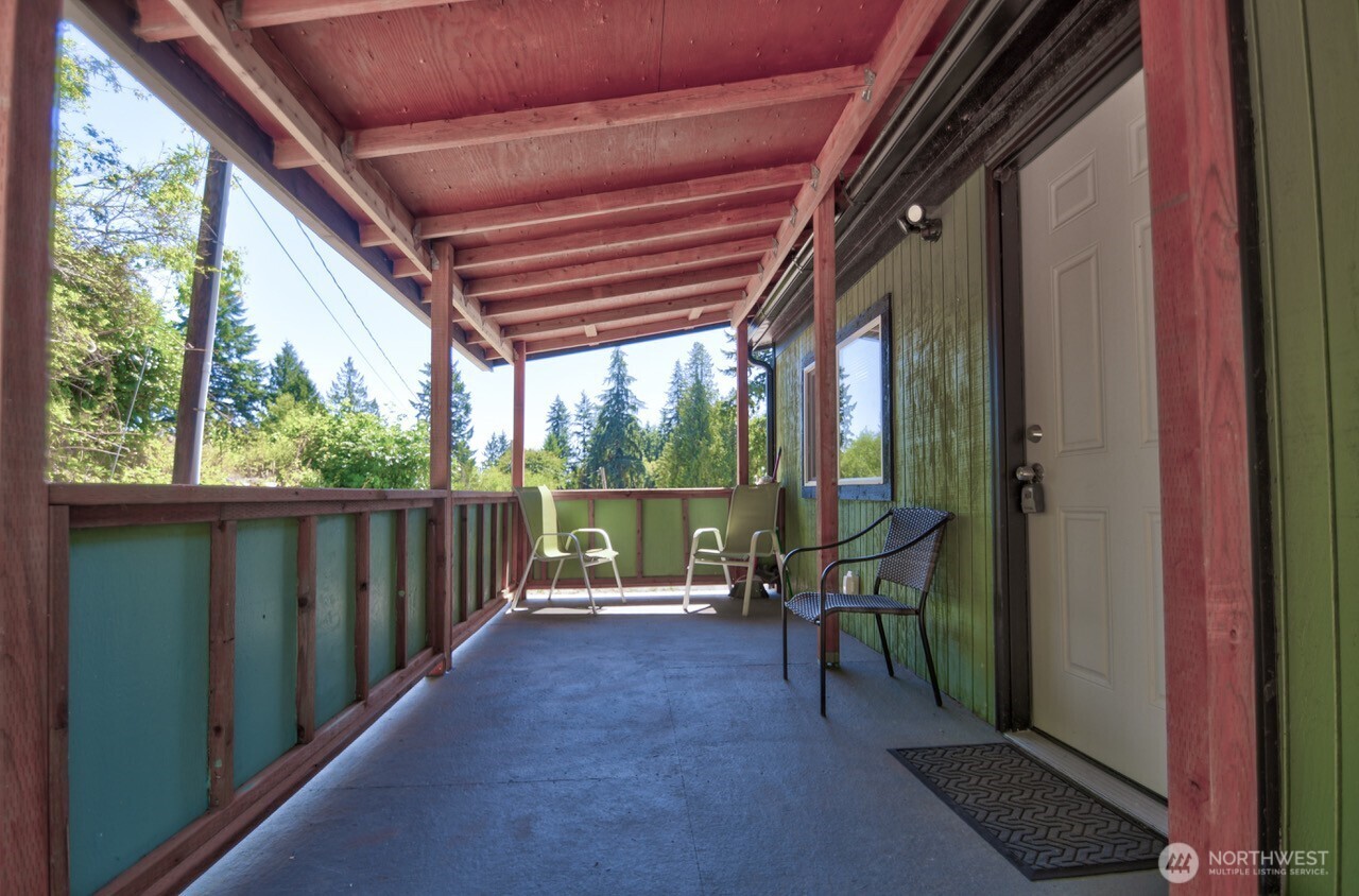 15503 Cedar Park Road Southeast, Unit 35C Olalla, WA 98359 - Photo 12 of 13 a view of a porch with chairs and backyard