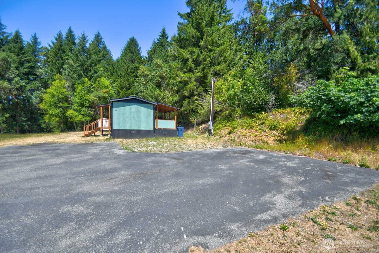 15503 Cedar Park Road Southeast, Unit 35C Olalla, WA 98359 - Photo 13 of 13 a house with trees in the background