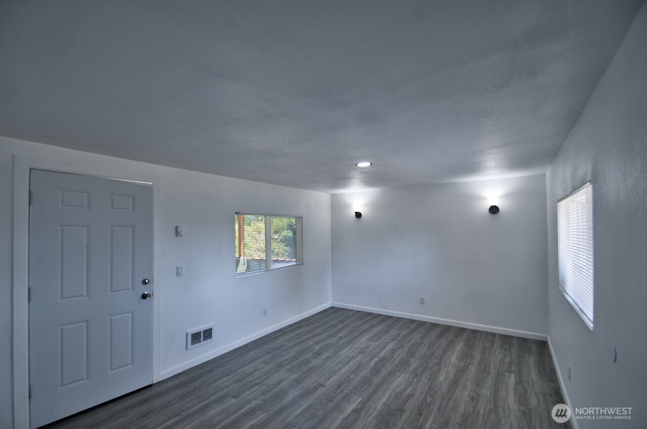 15503 Cedar Park Road Southeast, Unit 35C Olalla, WA 98359 - Photo 8 of 13 a view of an empty room with wooden floor and a window