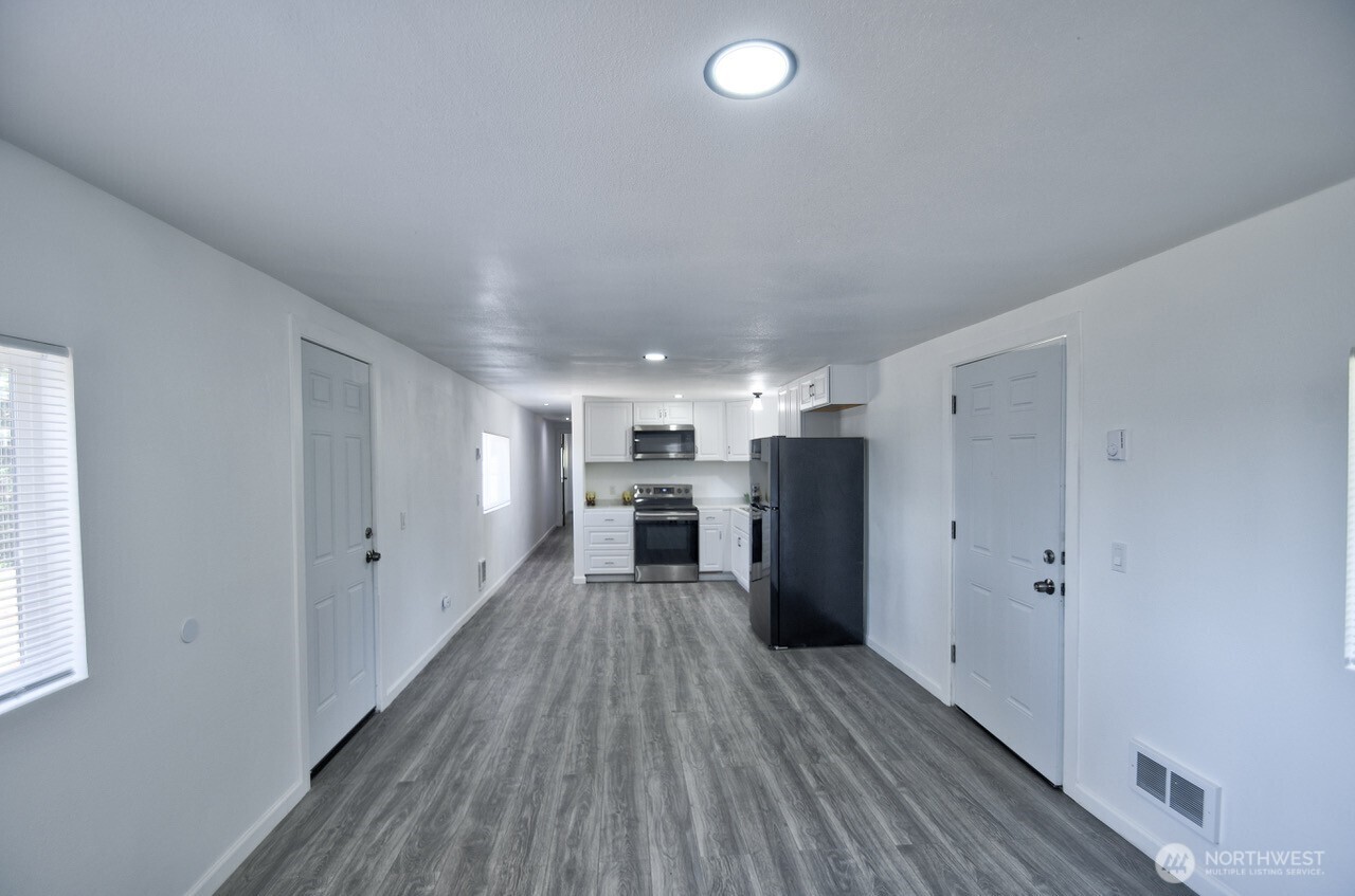 15503 Cedar Park Road Southeast, Unit 35C Olalla, WA 98359 - Photo 9 of 13 a view of a kitchen with refrigerator and wooden floor