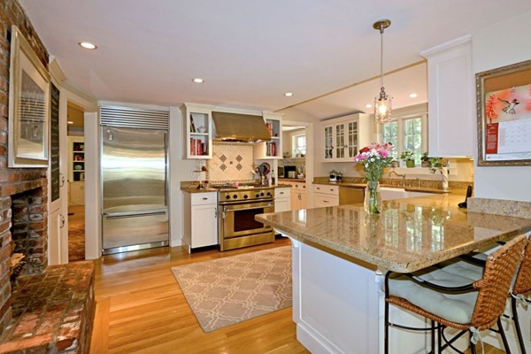 28 Sears Road Wayland, MA 01778 - Photo 13 of 30 a kitchen with stainless steel appliances granite countertop a refrigerator a stove and a dining table with wooden floor