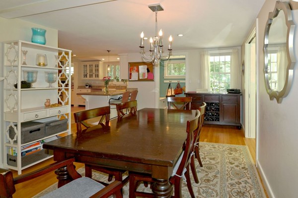 28 Sears Road Wayland, MA 01778 - Photo 17 of 30 a dining room with furniture a rug and a chandelier