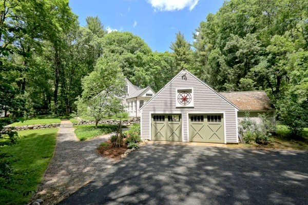 28 Sears Road Wayland, MA 01778 - Photo 2 of 30 a front view of a house with a yard and garage