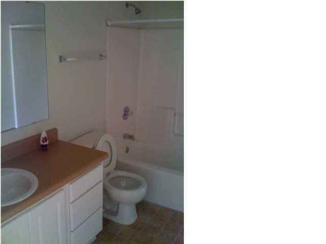 208 Limestone Circle Crestview, FL 32539 - Photo 16 of 20 a bathroom with a granite countertop toilet a sink and a mirror