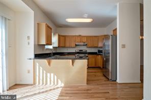 6348 Dakine Circle Springfield, VA 22150 - Photo 11 of 35 a kitchen with granite countertop a refrigerator and cabinets