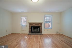 6348 Dakine Circle Springfield, VA 22150 - Photo 28 of 35 a view of an empty room with wooden floor fireplace and a window